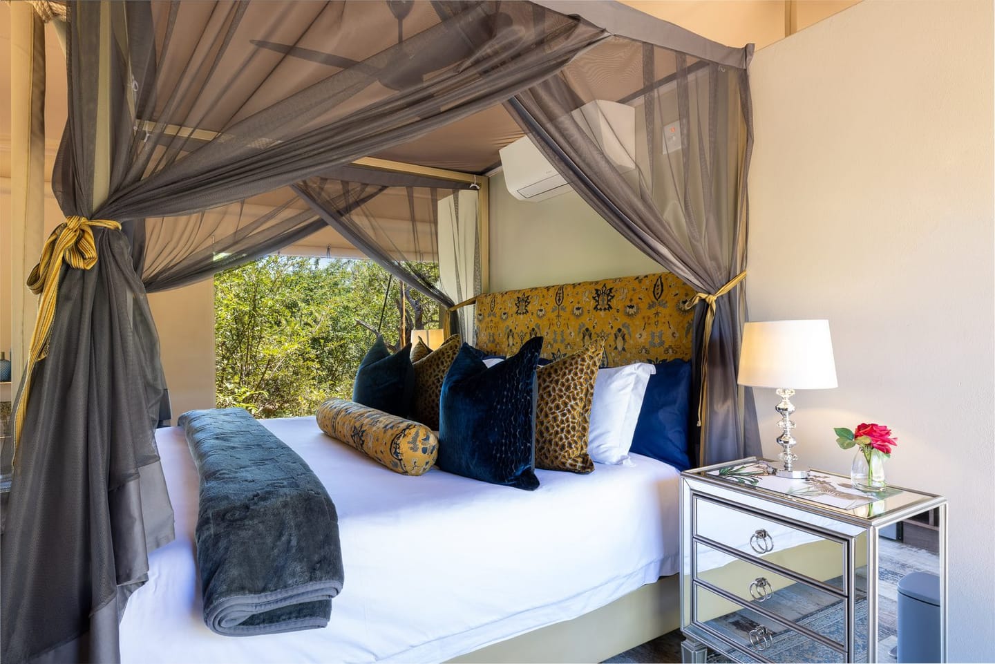 The bed inside the Milestone Royal Suite at Oase, with its classic safari-camp interior.